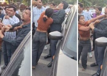 Video: बोनट पर चढ़कर रुकवाई कार, नीचे उतरते ही पति का कॉलर खींचकर पीटा… बीच सड़क मचा बवाल